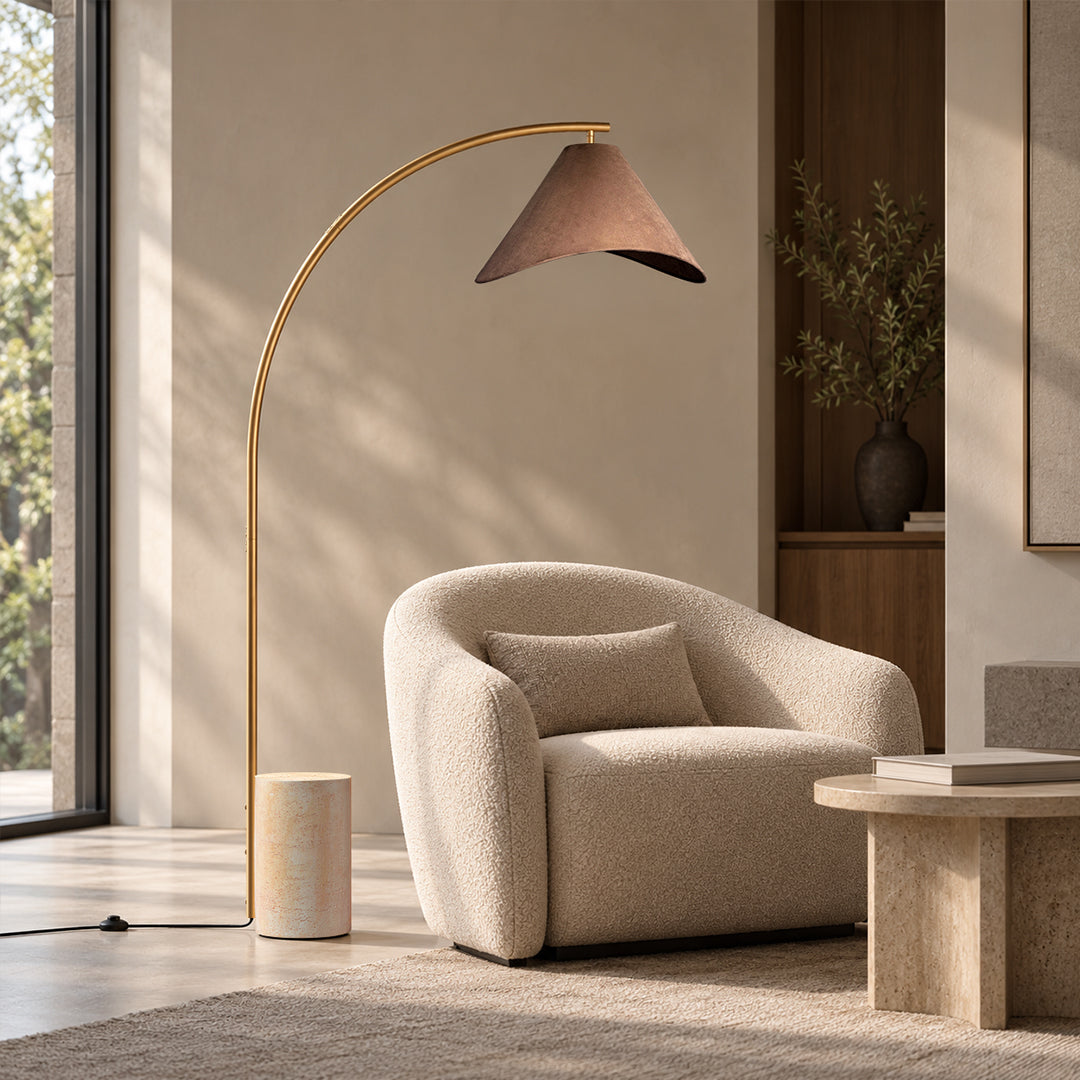 Arc floor lamp beside an armchair
